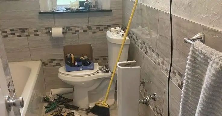 Bathroom with toilet and tools during a plumbing repair